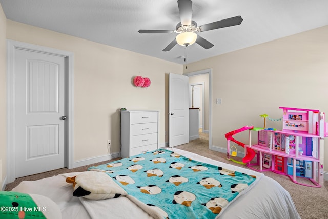 carpeted bedroom featuring ceiling fan and baseboards