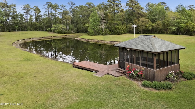 dock area with a water view and a lawn
