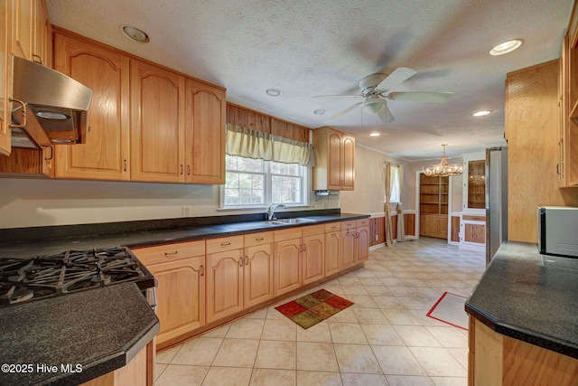 kitchen featuring range hood, a chandelier, a ceiling fan, a sink, and black microwave