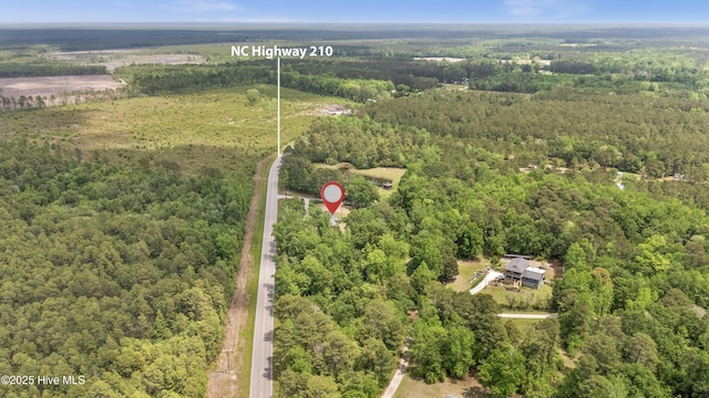 view of property location featuring a forest