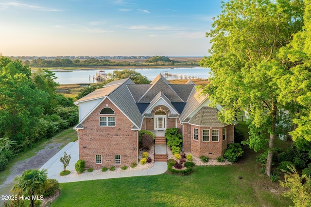 1835 Middle Sound Loop Rd, Wilmington, NC 28411 - view of front of property featuring brick siding, a front lawn, and a water view