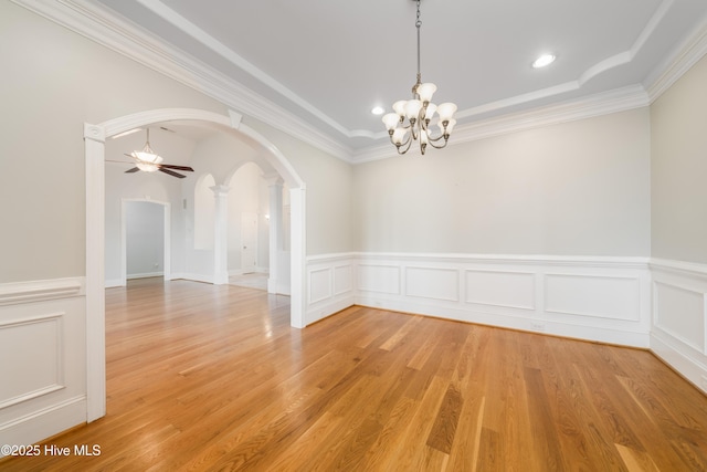 1835 Middle Sound Loop Rd, Wilmington, NC 28411 - spare room with arched walkways, a chandelier, a ceiling fan, wainscoting, and ornamental molding