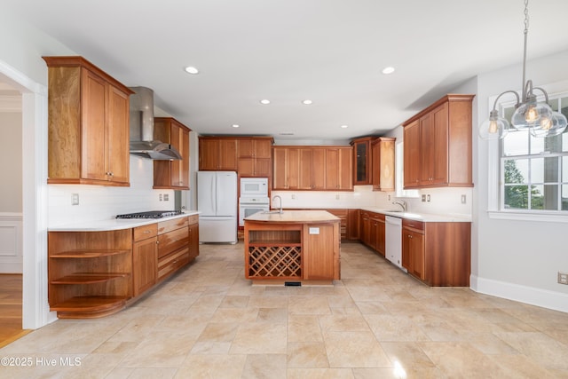 1835 Middle Sound Loop Rd, Wilmington, NC 28411 - kitchen featuring white appliances, wall chimney exhaust hood, a sink, brown cabinetry, and recessed lighting