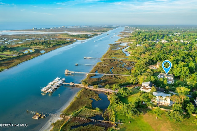 aerial view of property and surrounding area featuring a nearby body of water