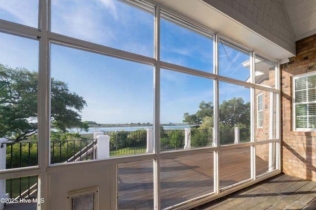 unfurnished sunroom featuring a water view and plenty of natural light