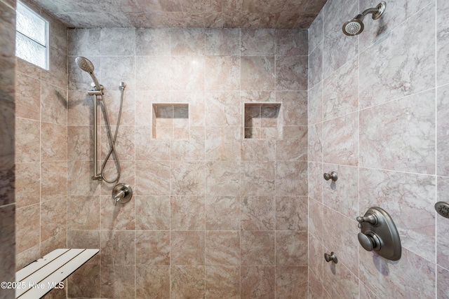 bathroom featuring a tile shower