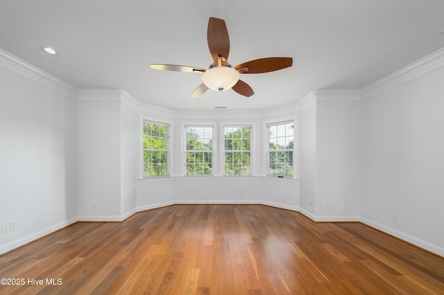 1835 Middle Sound Loop Rd, Wilmington, NC 28411 - empty room with healthy amount of natural light, ceiling fan, baseboards, wood finished floors, and crown molding