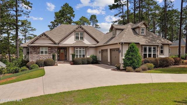216 National Dr, Pinehurst, NC 28374 - craftsman-style house featuring an attached garage, driveway, roof with shingles, and a front lawn