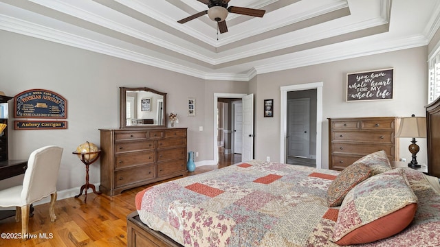 216 National Dr, Pinehurst, NC 28374 - bedroom featuring a tray ceiling, light wood-type flooring, baseboards, and crown molding