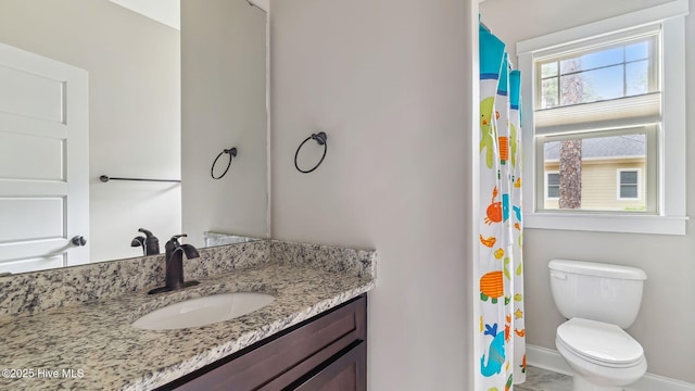 216 National Dr, Pinehurst, NC 28374 - bathroom with baseboards, vanity, toilet, and curtained shower