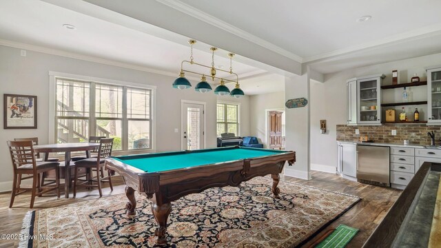 216 National Dr, Pinehurst, NC 28374 - playroom featuring bar with sink, light wood finished floors, pool table, ornamental molding, and baseboards