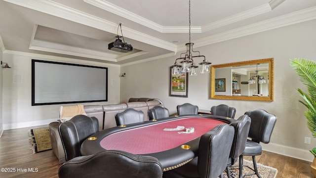 216 National Dr, Pinehurst, NC 28374 - cinema room featuring a raised ceiling, wood finished floors, a chandelier, baseboards, and ornamental molding