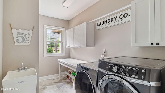 216 National Dr, Pinehurst, NC 28374 - washroom featuring cabinet space, separate washer and dryer, baseboards, and light marble finish flooring