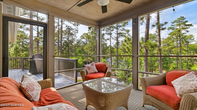 216 National Dr, Pinehurst, NC 28374 - sunroom featuring a ceiling fan, plenty of natural light, and view of wooded area