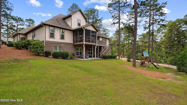 216 National Dr, Pinehurst, NC 28374 - back of house featuring a sunroom, a patio, a lawn, a playground, and brick siding