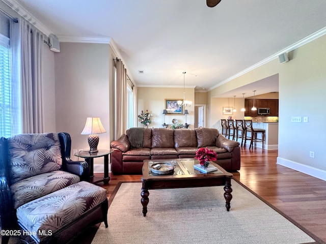 6832 Main St Unit 317, Wilmington, NC 28405 - living area featuring wood finished floors, plenty of natural light, ornamental molding, and a chandelier