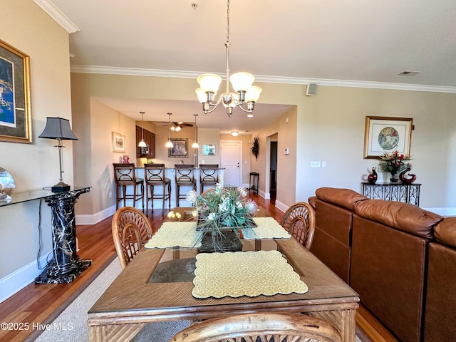 6832 Main St Unit 317, Wilmington, NC 28405 - dining space featuring wood finished floors, a chandelier, ornamental molding, and ceiling fan