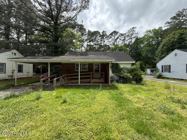 113 Winesett Cir, Plymouth, NC 27962 - back of property with a lawn, view of scattered trees, and covered porch