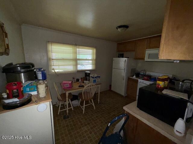 113 Winesett Cir, Plymouth, NC 27962 - kitchen featuring white appliances, light countertops, brown cabinets, and carpet floors