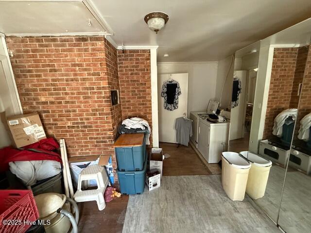 113 Winesett Cir, Plymouth, NC 27962 - clothes washing area featuring washer / clothes dryer, wood finished floors, brick wall, and ornamental molding
