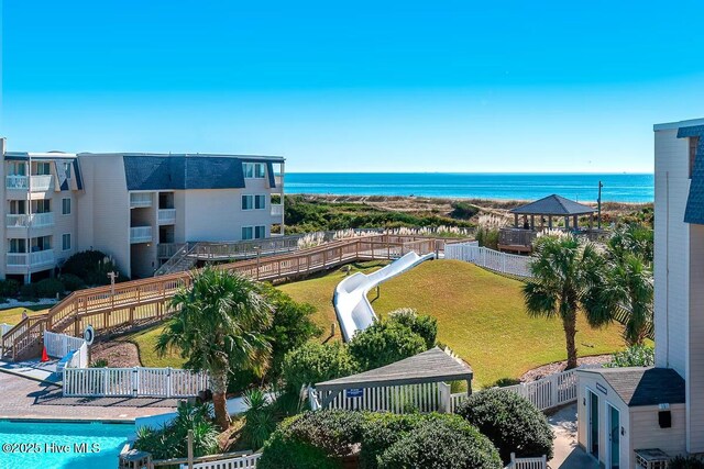 bird's eye view of a nearby body of water and a pool area
