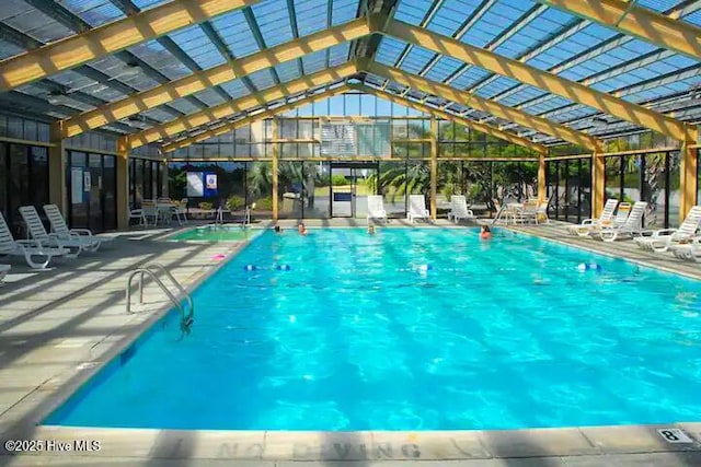 indoor community pool featuring a patio area