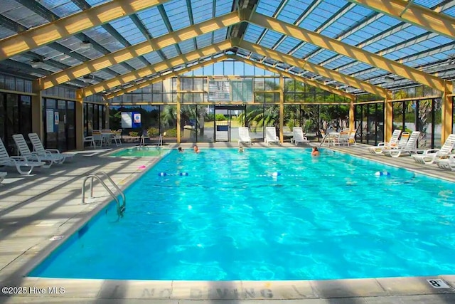 indoor community pool featuring a patio