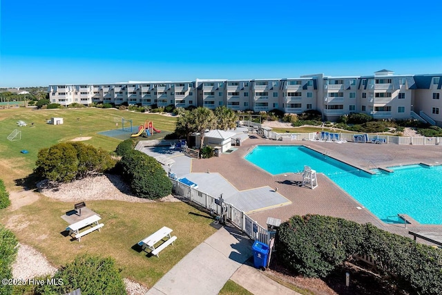community pool featuring a yard