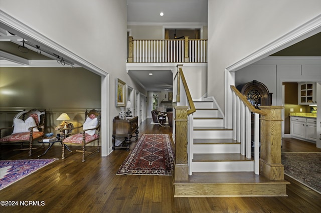 390 Whitebridge Rd, Hampstead, NC 28443 - foyer featuring ornamental molding, stairway, hardwood / wood-style floors, and a towering ceiling