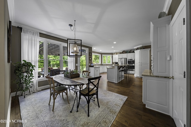 390 Whitebridge Rd, Hampstead, NC 28443 - dining space with ornamental molding, dark wood-style floors, and recessed lighting