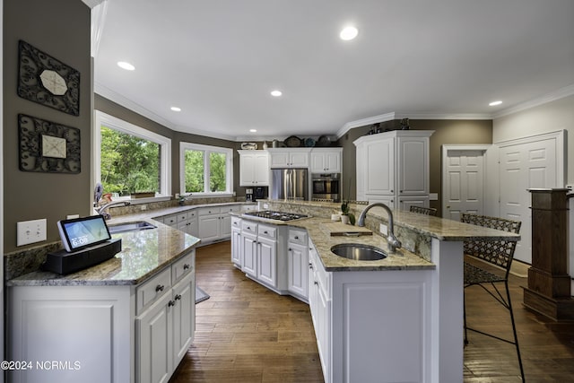 390 Whitebridge Rd, Hampstead, NC 28443 - kitchen with crown molding, a kitchen breakfast bar, appliances with stainless steel finishes, and a sink