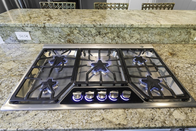390 Whitebridge Rd, Hampstead, NC 28443 - room details with light stone countertops and stainless steel gas cooktop