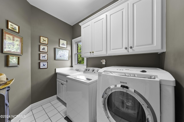 390 Whitebridge Rd, Hampstead, NC 28443 - laundry room with a sink, cabinet space, washer and dryer, light tile patterned floors, and baseboards