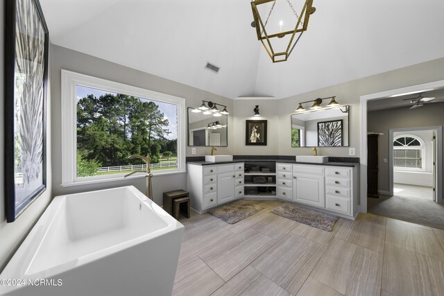 390 Whitebridge Rd, Hampstead, NC 28443 - bathroom featuring ceiling fan with notable chandelier, vanity, high vaulted ceiling, visible vents, and a freestanding bath