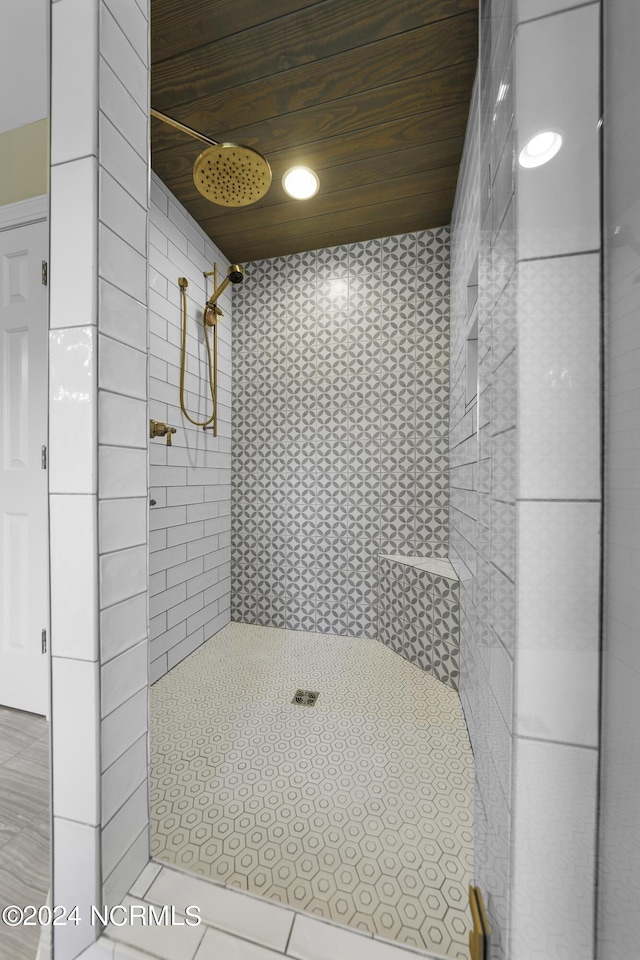 390 Whitebridge Rd, Hampstead, NC 28443 - bathroom featuring a tile shower, tile patterned floors, and wood ceiling
