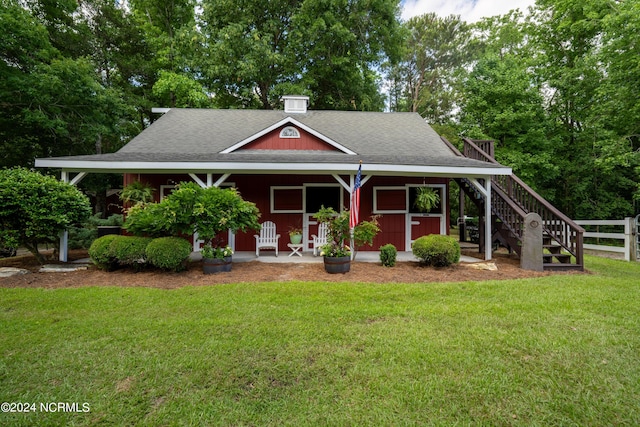 390 Whitebridge Rd, Hampstead, NC 28443 - view of front of property with fence, stairs, a shingled roof, a porch, and a front lawn
