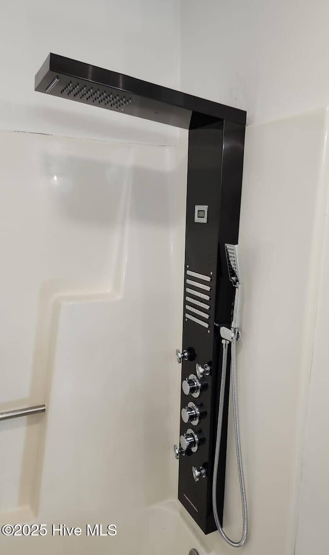 bathroom view of tub / shower combination