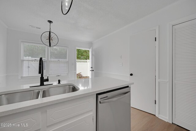 kitchen with stove, a peninsula, refrigerator, white cabinets, and light countertops