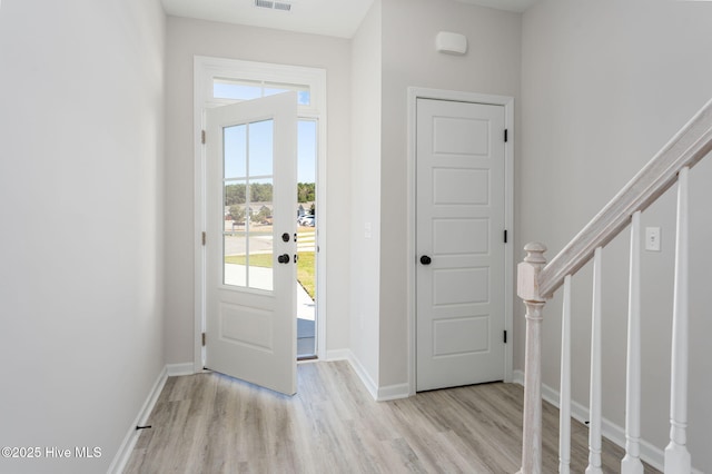 130 Jansen Ln, Winnabow, NC 28479 - foyer with plenty of natural light, visible vents, wood finished floors, and stairs