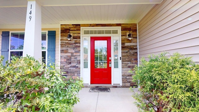 149 Mardella Way, Holly Ridge, NC 28445 - doorway to property with stone siding and covered porch