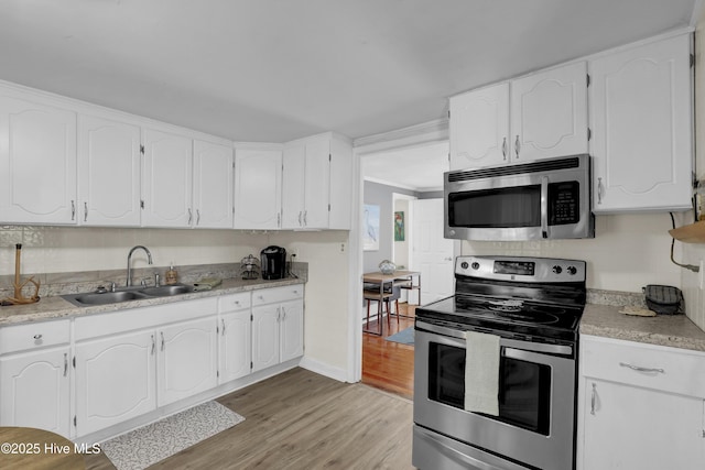 3950 NC Highway 50, Maple Hill, NC 28454 - kitchen featuring appliances with stainless steel finishes, a sink, white cabinetry, and ornamental molding