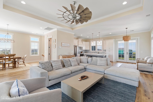 1063 Tide Ridge Dr, Supply, NC 28462 - living room with light wood-style flooring, french doors, recessed lighting, ceiling fan, and ornamental molding