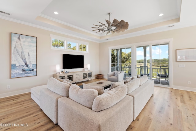 1063 Tide Ridge Dr, Supply, NC 28462 - living area with a tray ceiling, crown molding, light wood finished floors, baseboards, and recessed lighting