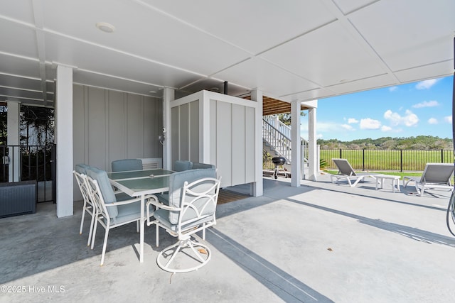 1063 Tide Ridge Dr, Supply, NC 28462 - view of patio featuring stairs, fence, and outdoor dining space