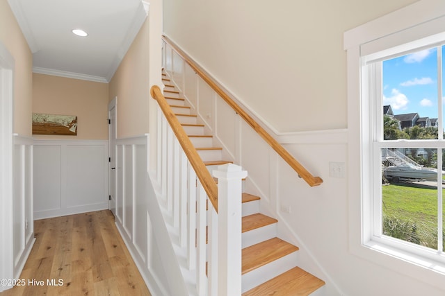 1063 Tide Ridge Dr, Supply, NC 28462 - staircase with a decorative wall, wood finished floors, wainscoting, ornamental molding, and recessed lighting