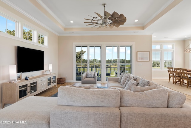 1063 Tide Ridge Dr, Supply, NC 28462 - living room featuring a raised ceiling, ornamental molding, wood finished floors, baseboards, and recessed lighting