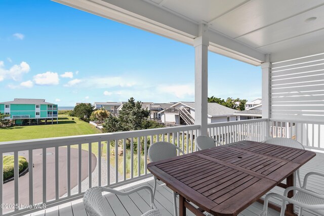 1063 Tide Ridge Dr, Supply, NC 28462 - wooden deck featuring outdoor dining area, a residential view, and a yard