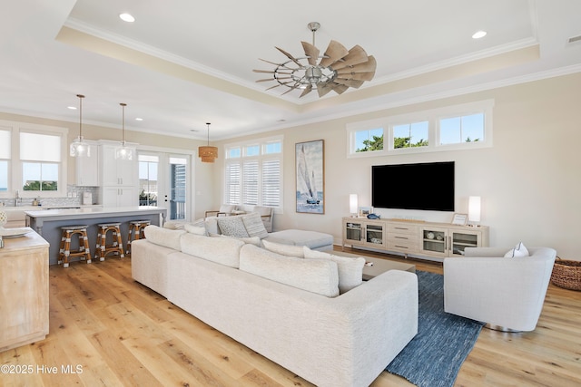 1063 Tide Ridge Dr, Supply, NC 28462 - living room featuring a raised ceiling, light wood finished floors, recessed lighting, and crown molding