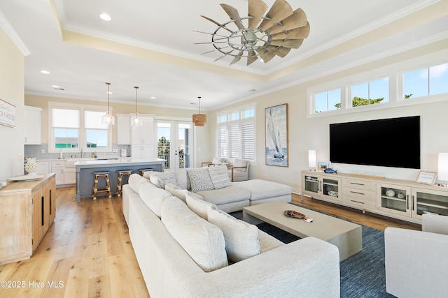 1063 Tide Ridge Dr, Supply, NC 28462 - living area with a ceiling fan, light wood-style flooring, a raised ceiling, ornamental molding, and recessed lighting