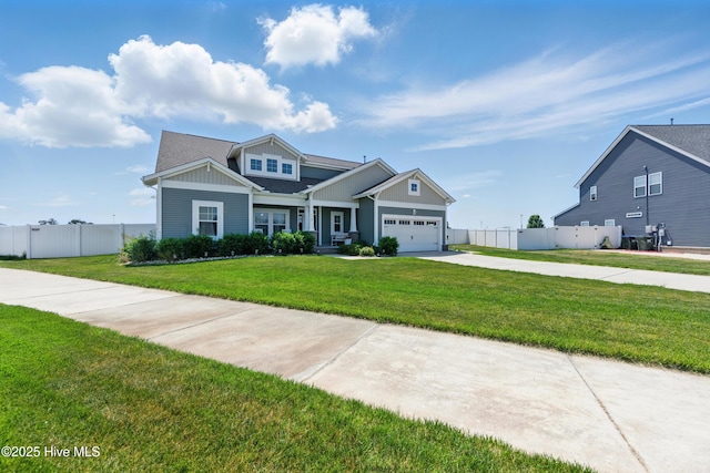 craftsman inspired home with driveway, board and batten siding, a front yard, and fence